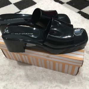 A pair of shiny black patent chunky heels